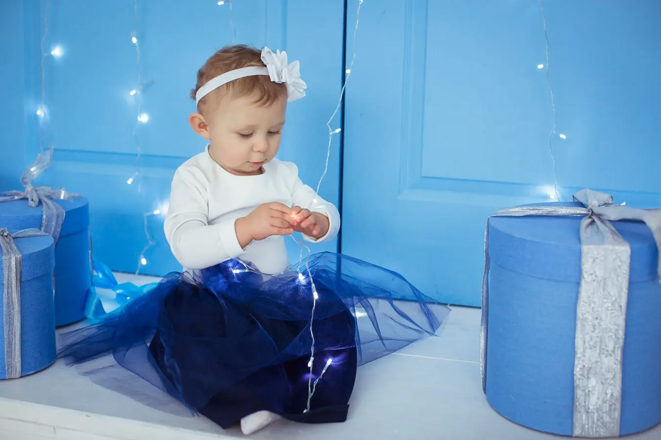дитяча фотосесія Львів, дівчинка з гірляндою та подарунками, професійна зйомка дітей, святкова фотосесія в студії, портфоліо RoStudio.